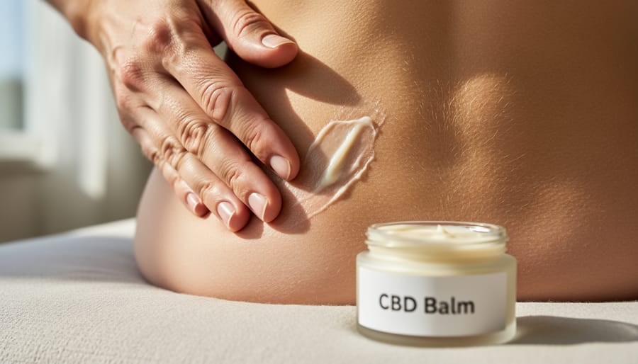 Person applying CBD pain relief balm to an aching knee at home.